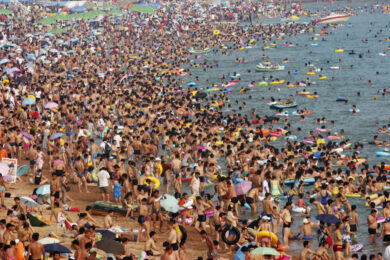 People play on a beach in Qingdao
